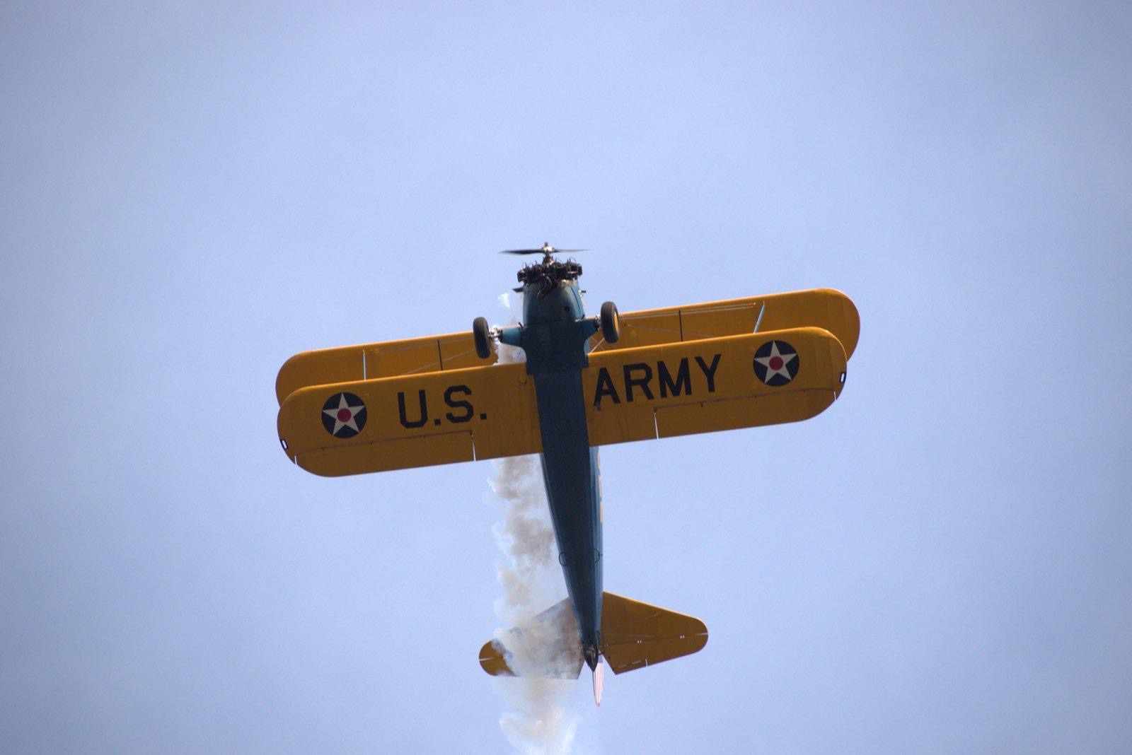 Underside view of the U.S. Army Stearman trailing smoke