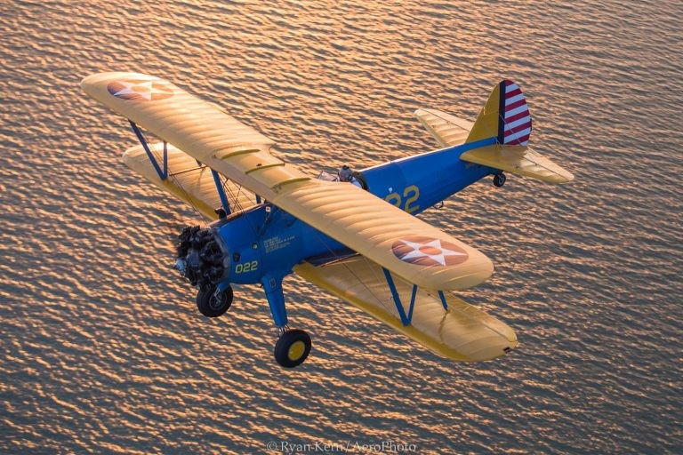 Biplane flying over the beaches of St. Petersburg